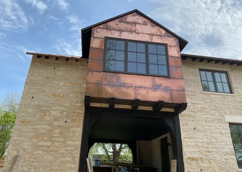 Copper metal panel facade on a stone building for Metal Roof Coating in Cedar Park