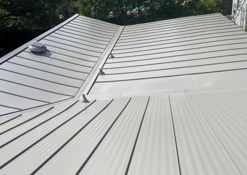 Solar attic fan installed on a metal roof for Roof Ventilation in Cedar Park